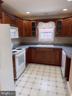 kitchen with white appliances and sink