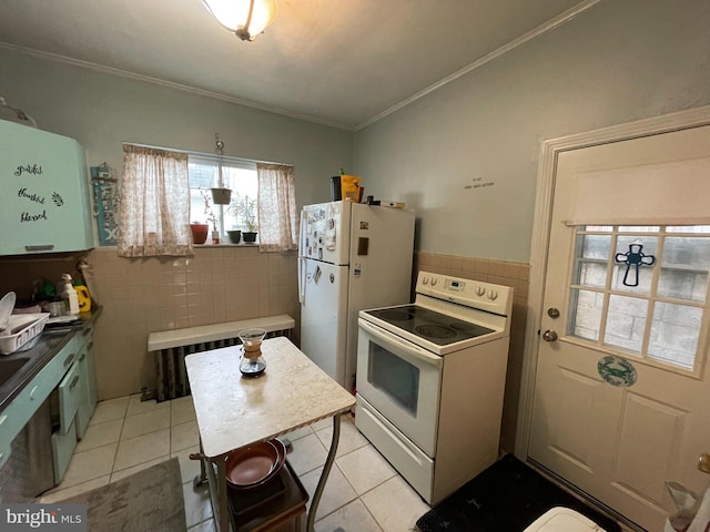 kitchen with tile walls, crown molding, light tile patterned floors, and white appliances