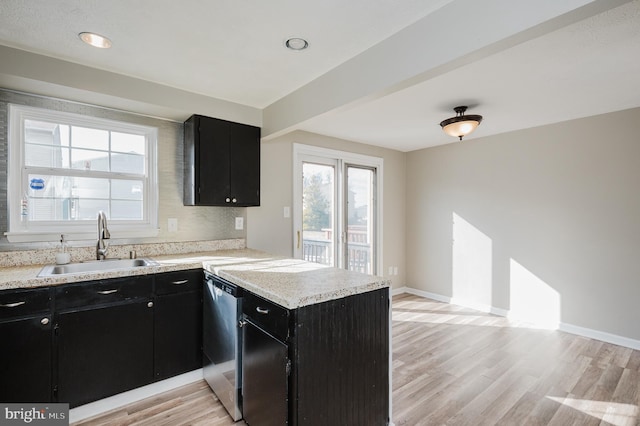 kitchen with kitchen peninsula, dishwasher, light hardwood / wood-style flooring, and sink