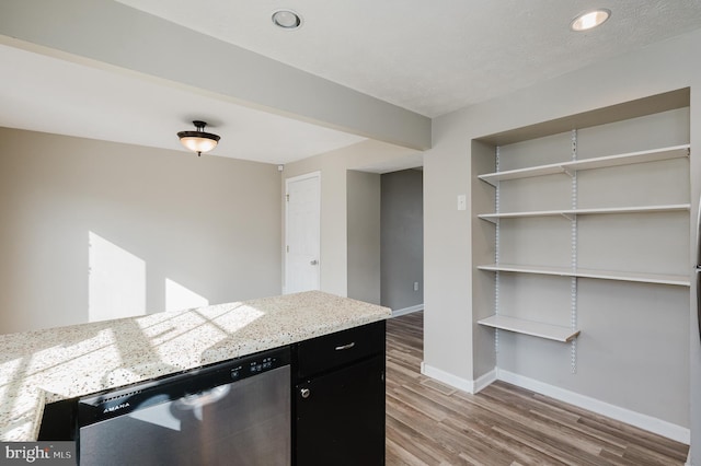 kitchen featuring dishwasher and hardwood / wood-style floors