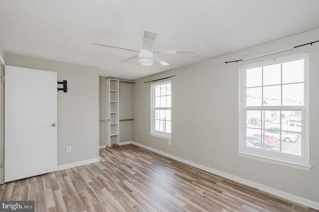 unfurnished bedroom featuring ceiling fan and light wood-type flooring