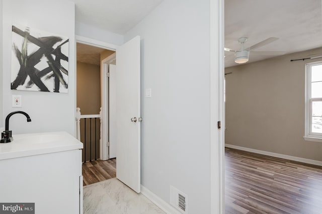 bathroom with ceiling fan and sink