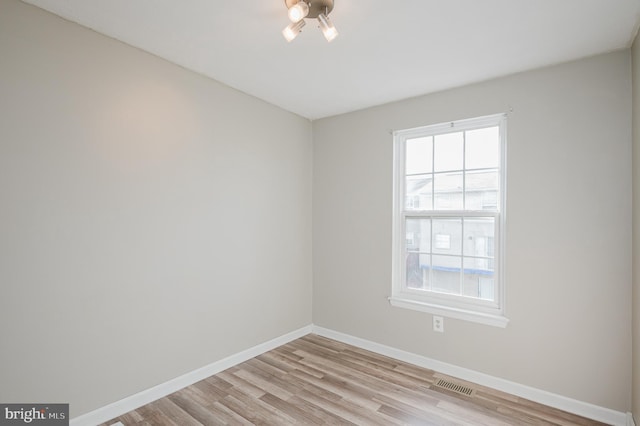 spare room with light hardwood / wood-style floors