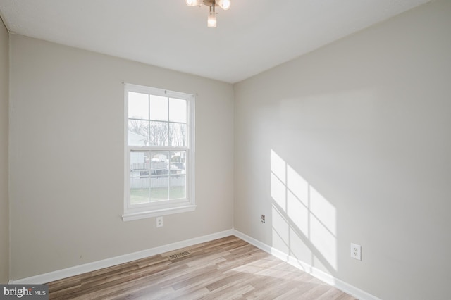 spare room with light hardwood / wood-style floors