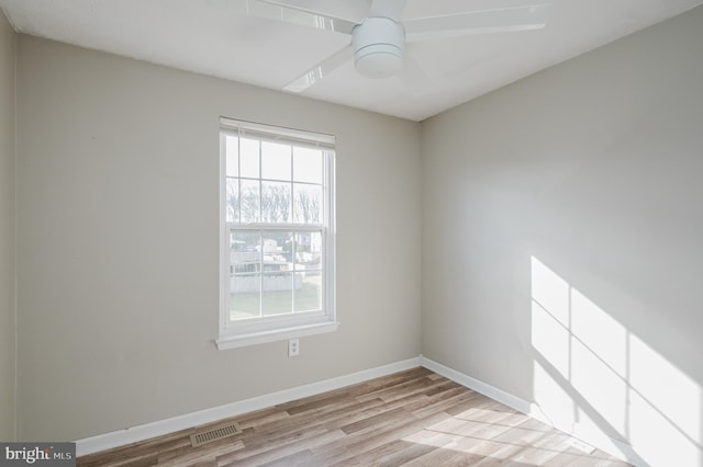 spare room with ceiling fan and light wood-type flooring