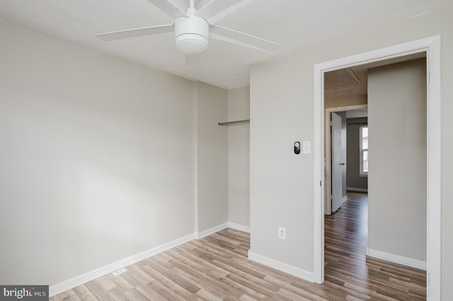 spare room with light wood-type flooring and ceiling fan