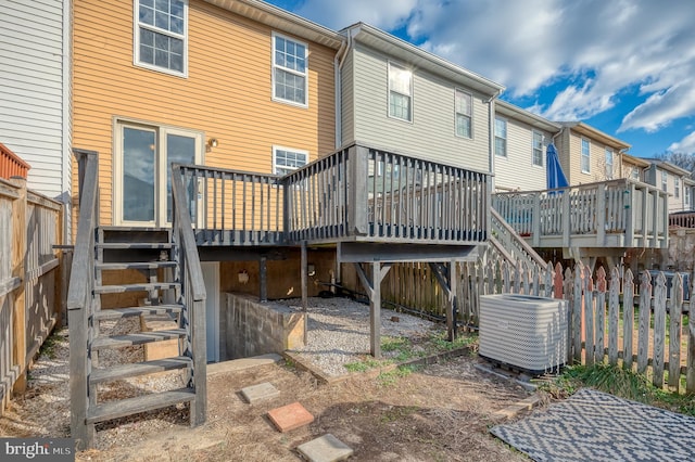 back of property featuring cooling unit and a deck