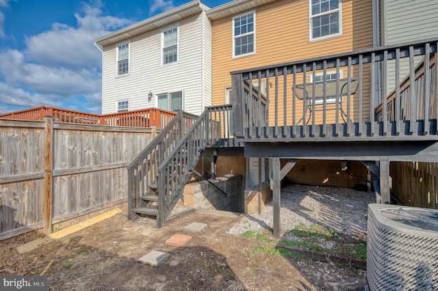 back of property featuring cooling unit and a deck