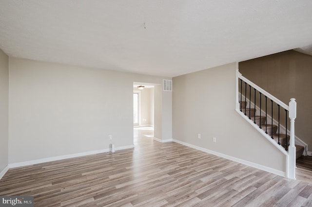 spare room featuring light hardwood / wood-style flooring