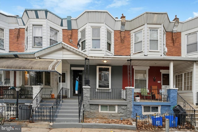 townhome / multi-family property featuring a porch