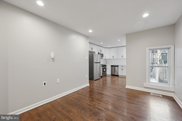 unfurnished living room featuring dark hardwood / wood-style floors