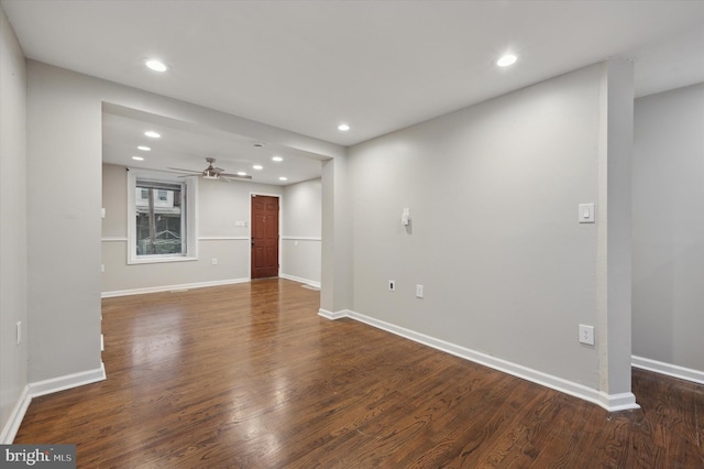 unfurnished living room with dark hardwood / wood-style flooring and ceiling fan