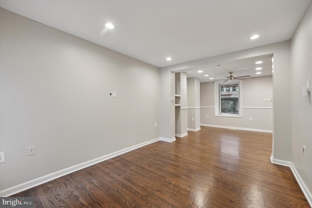 unfurnished living room with ceiling fan and dark hardwood / wood-style flooring