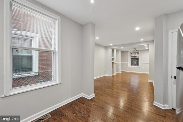 interior space with dark hardwood / wood-style floors and ceiling fan