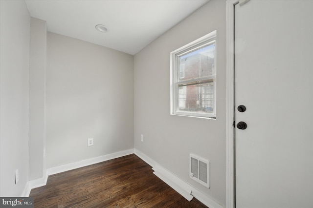 unfurnished room with dark hardwood / wood-style flooring