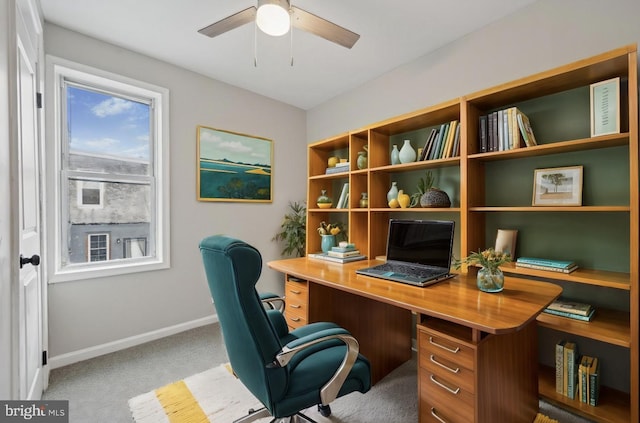 carpeted office with ceiling fan