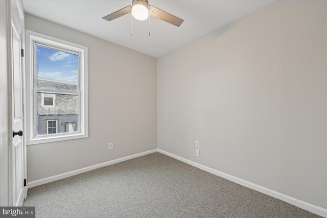 spare room with carpet floors and ceiling fan