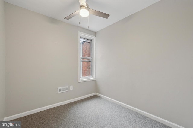 carpeted spare room featuring ceiling fan