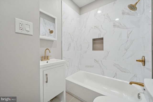 bathroom with vanity, tile patterned floors, and tiled shower / bath