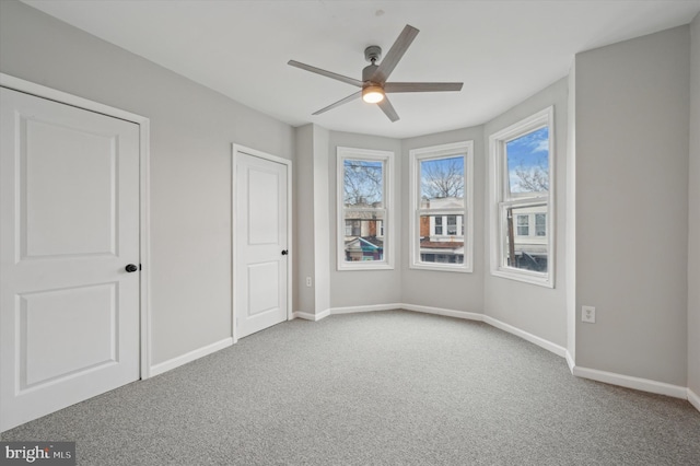 unfurnished bedroom featuring ceiling fan and light colored carpet