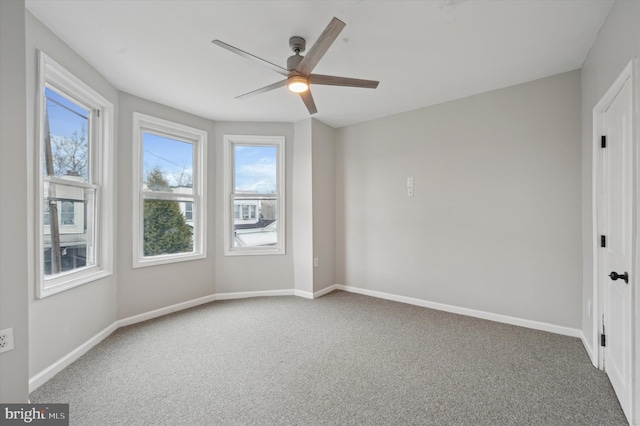 unfurnished room featuring ceiling fan, plenty of natural light, and carpet floors