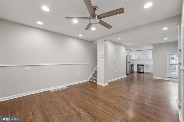 unfurnished living room with ceiling fan and dark hardwood / wood-style floors