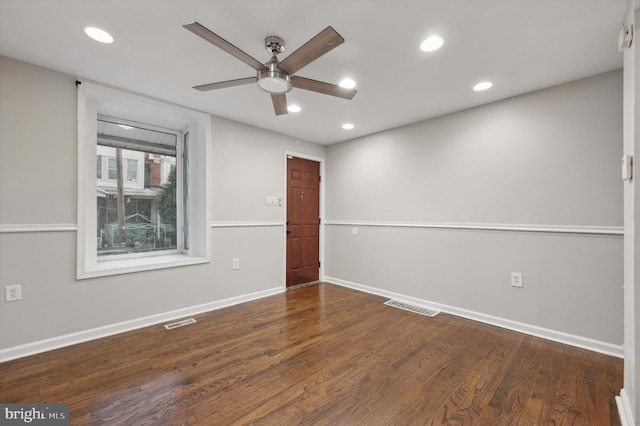 unfurnished room with dark hardwood / wood-style floors and ceiling fan