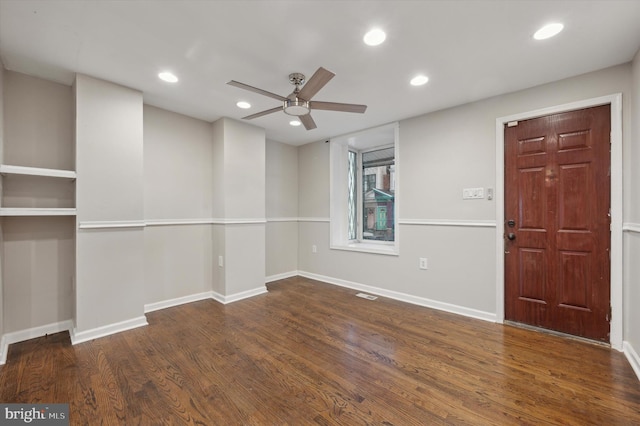 empty room featuring dark hardwood / wood-style floors and ceiling fan