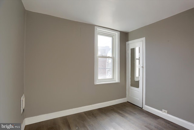 empty room featuring hardwood / wood-style flooring and a wealth of natural light