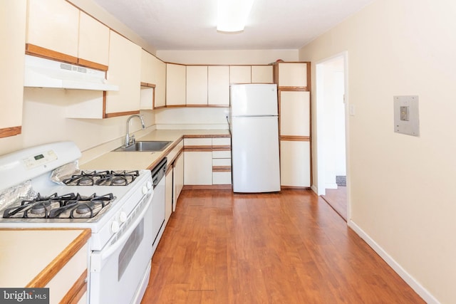 kitchen featuring light wood-type flooring, white appliances, white cabinets, and sink