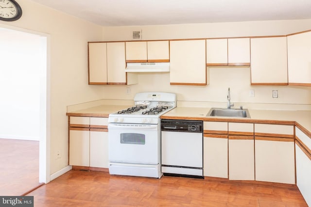 kitchen with white appliances, white cabinetry, light hardwood / wood-style flooring, and sink