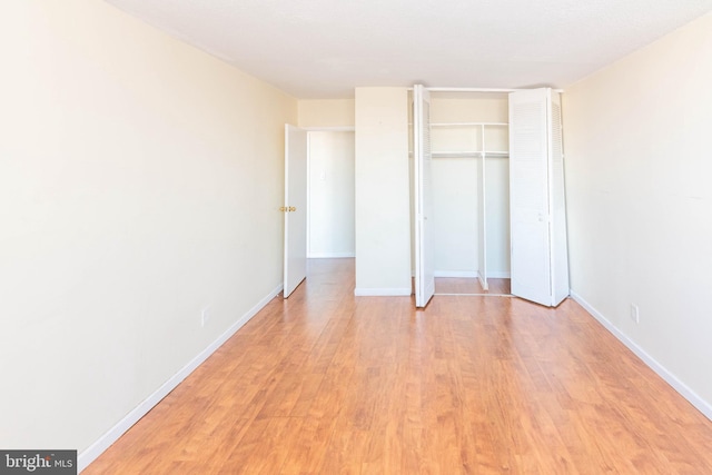 unfurnished bedroom featuring light hardwood / wood-style floors and a closet