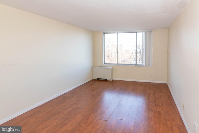 unfurnished room featuring hardwood / wood-style flooring