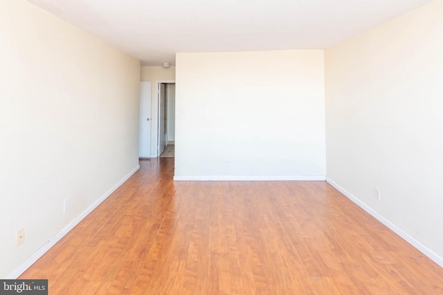 unfurnished room with light wood-type flooring