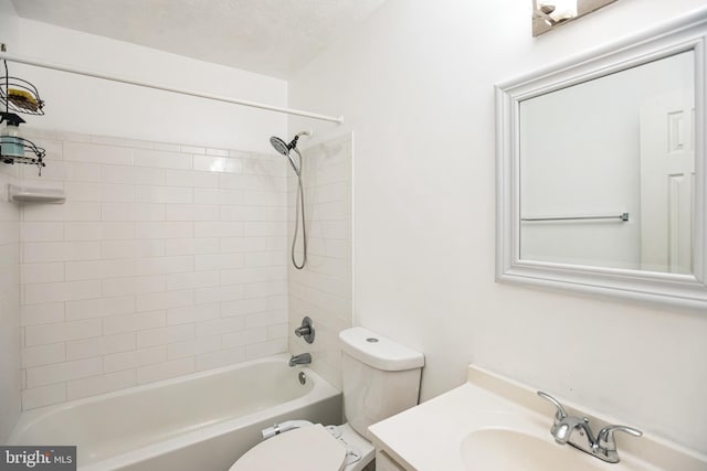 full bathroom featuring a textured ceiling, vanity, toilet, and tiled shower / bath