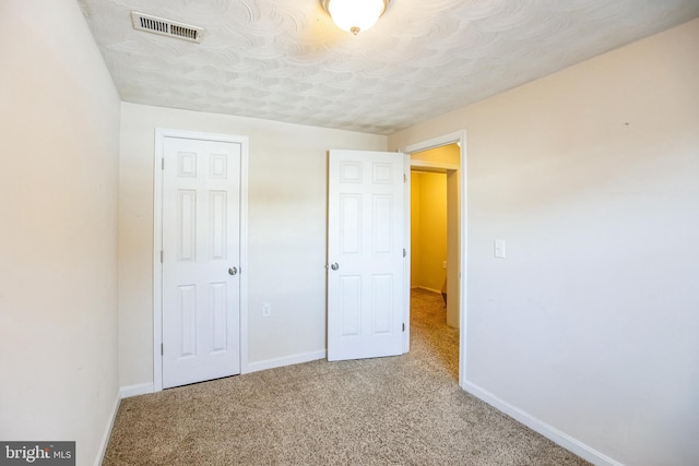 unfurnished bedroom featuring light carpet