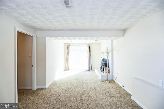 unfurnished room featuring carpet flooring and a textured ceiling