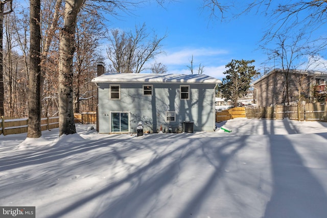 view of snow covered rear of property