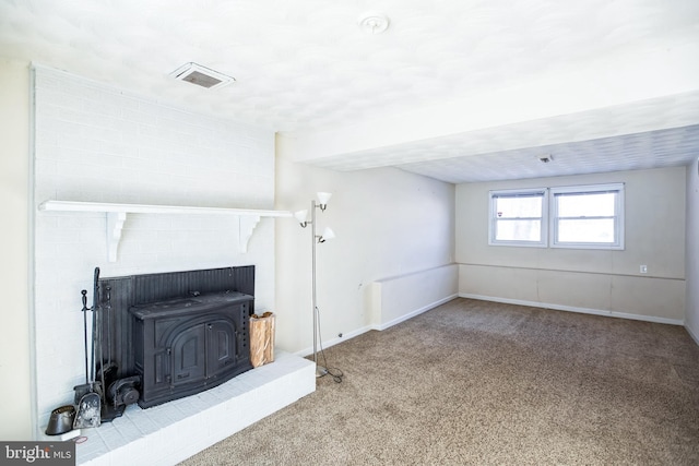 unfurnished living room with carpet flooring and a wood stove