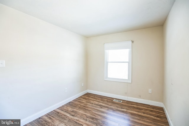 unfurnished room featuring dark hardwood / wood-style flooring