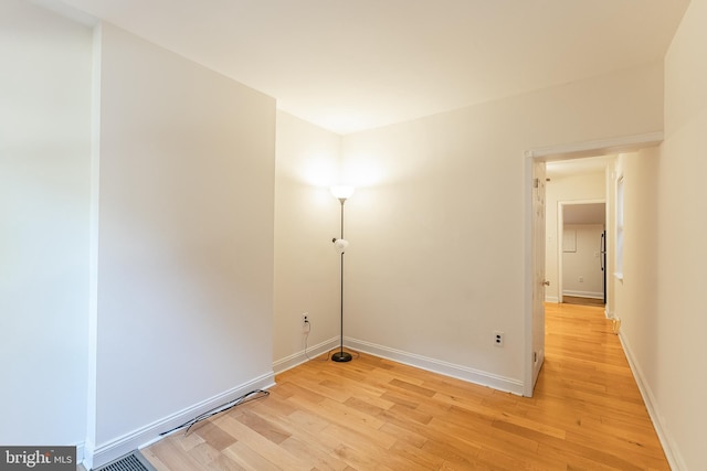 laundry area featuring light wood-type flooring