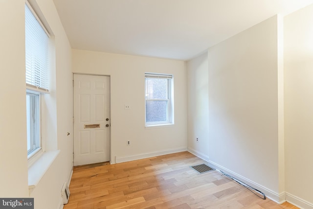 spare room with light wood-type flooring