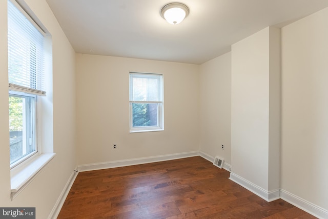 empty room with dark wood-type flooring