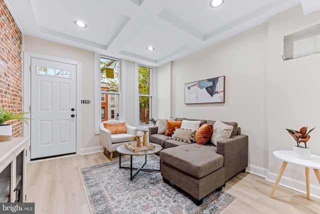 living room featuring coffered ceiling, beamed ceiling, and light hardwood / wood-style flooring