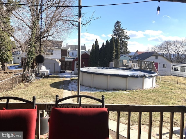 view of yard featuring a storage unit and a covered pool