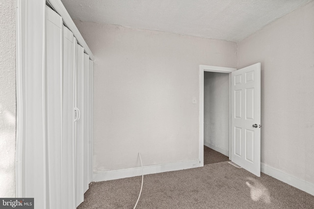 unfurnished bedroom with carpet flooring and a closet