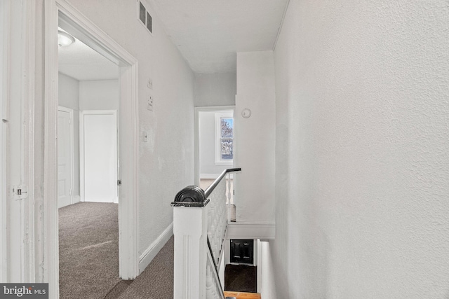 corridor with carpet flooring