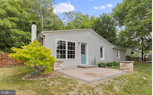 back of house featuring a yard and a patio area