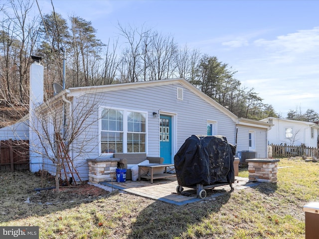 rear view of property featuring a yard and a patio