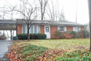 ranch-style home with a front yard and a carport